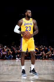 LeBron James wearing white socks with yellow-purple jersey